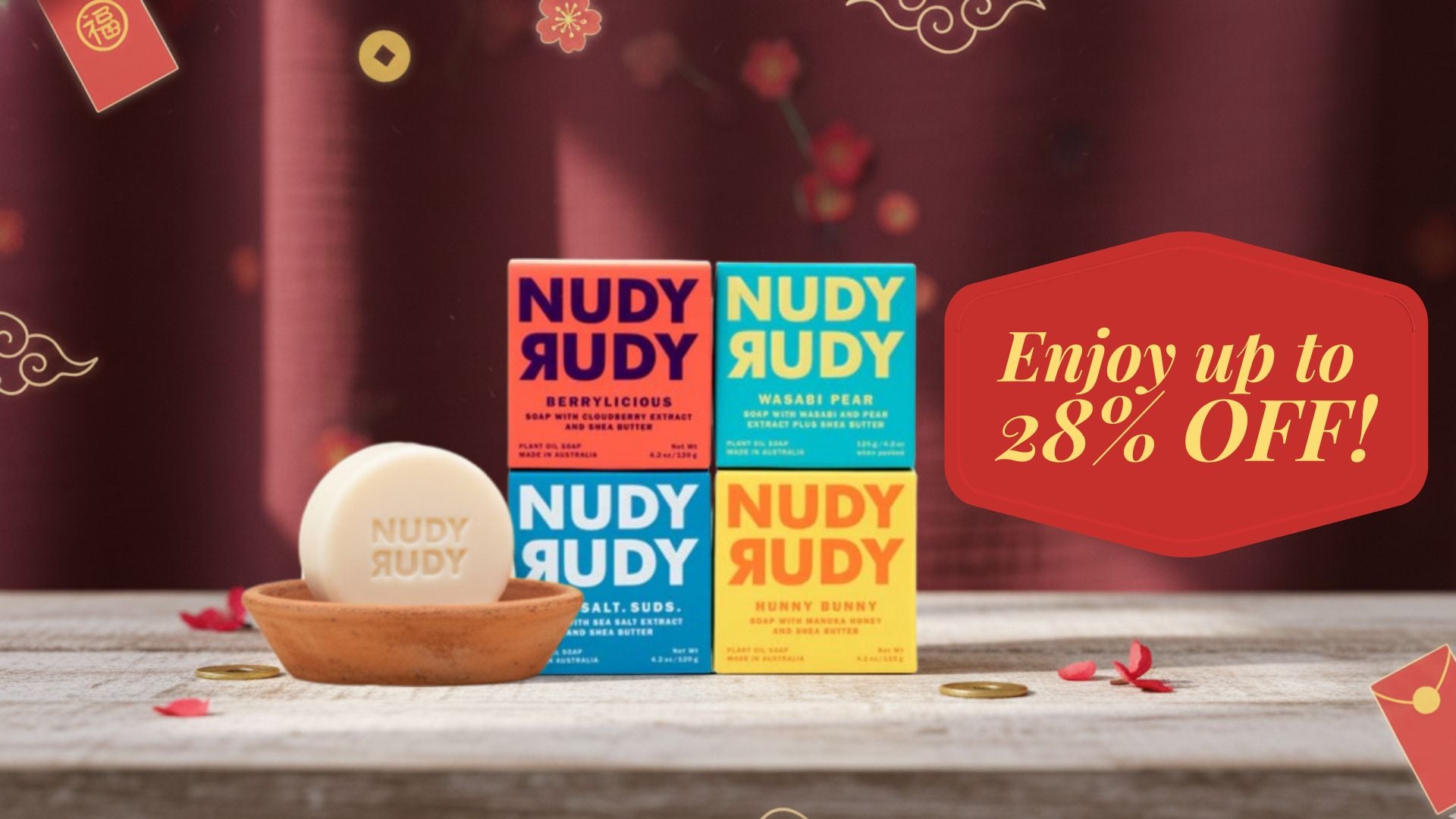 Nudy Rudy soap bars and packaging with a promotional offer on a wooden surface.