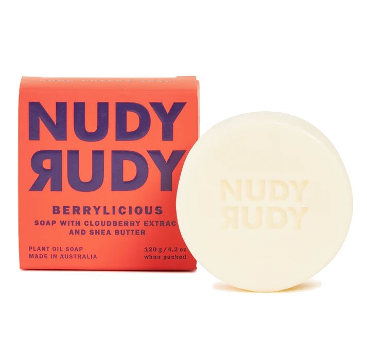 An assortment of Nudy Rudy bar soap packaging in various colors and flavors displayed on a bright background.